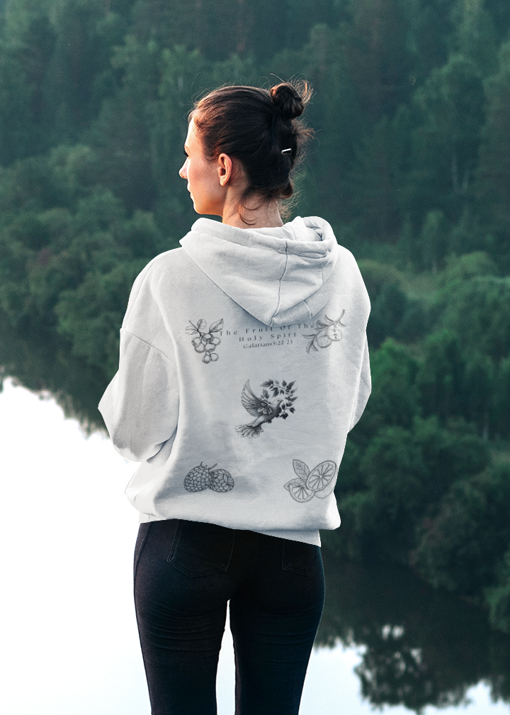 Back view of woman wearing white Fruit of the Holy Spirit hoodie with Galatians 5:22-23 Bible verse, dove, and fruit illustrations.