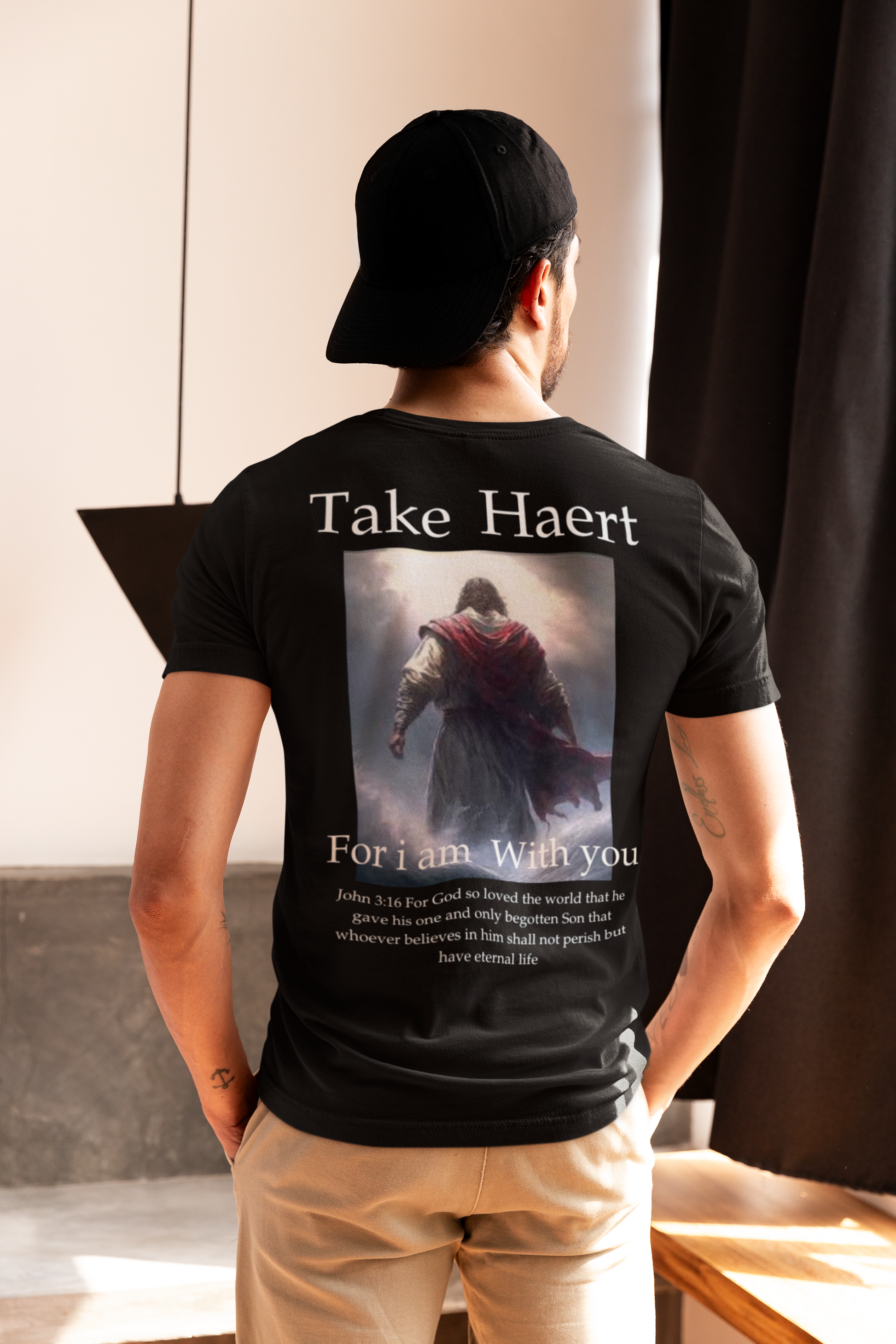 back view of a men wearing a black Bible verse shirt clothing featuring John 3:16 — faith-based design for men’s Christian apparel and Catholic clothing styles.