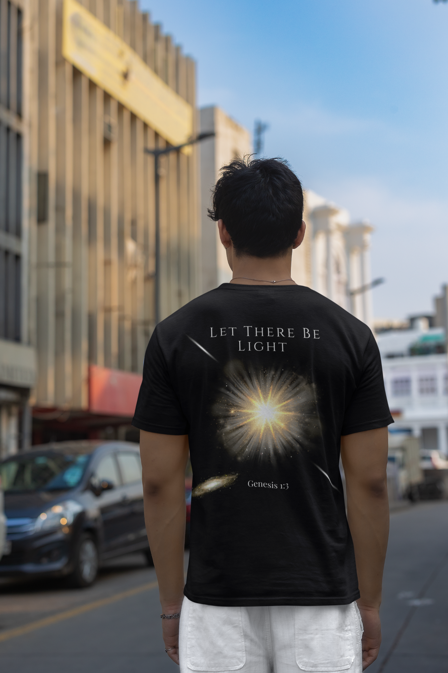 Let There Be Light Genesis 1:3 t-shirt featuring a radiant light burst design—modern Christian apparel for men and women. This Bible verse shirt blends faith and fashion, perfect for those seeking trendy Christian clothing, Bible verse encouragement, and bold Christian clothes that inspire.
