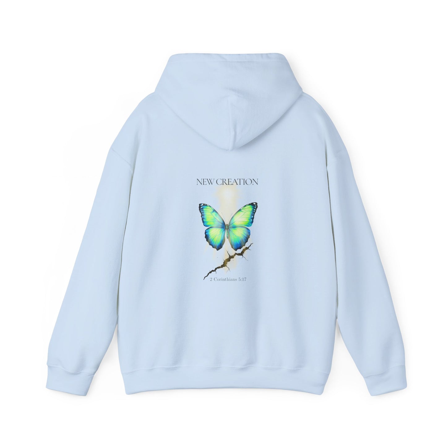 Light blue Christian hoodie featuring a blue and green butterfly rising above a cracked rock, symbolizing transformation and renewal. The design includes the words 'NEW CREATION' at the top and '2 Corinthians 5:17' at the bottom, representing the Bible verse about becoming a new creation in Christ.