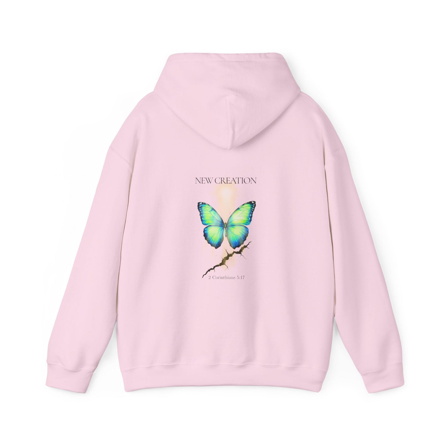 light pink Christian hoodie featuring a blue and green butterfly rising above a cracked rock, symbolizing transformation and renewal. The design includes the words 'NEW CREATION' at the top and '2 Corinthians 5:17' at the bottom, representing the Bible verse about becoming a new creation in Christ.