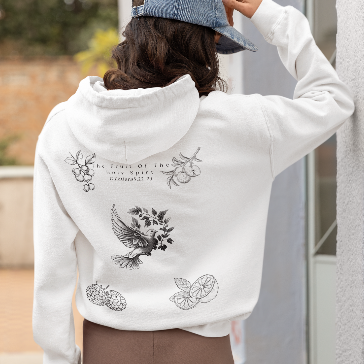 Back view of a Women wearing a Fruit of the Holy Spirit hoodie with Galatians 5:22-23 Bible verse, Christian faith-based design promoting love, joy, peace, and kindness